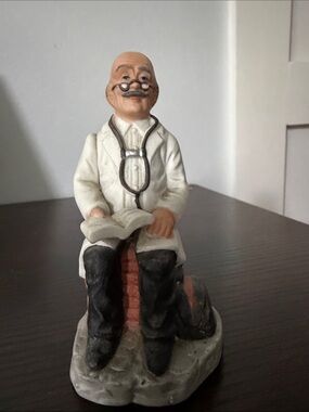 Doctor Figurine Reading with Stethoscope